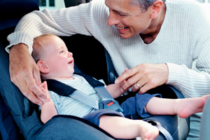 dad with infant in car seat; father and baby in car