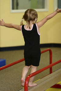 young girl on balance beam