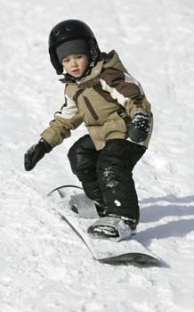 young boy snowboarding