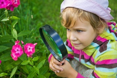 summer-learning; girl-gardening-and-looking-at-flower