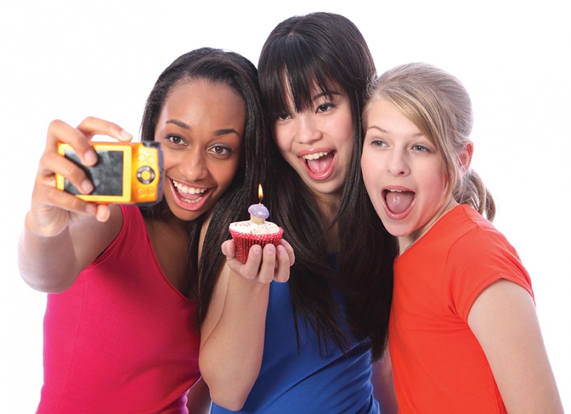 Planning a Tween's Birthday Party three tween girls taking selfie with cupcake