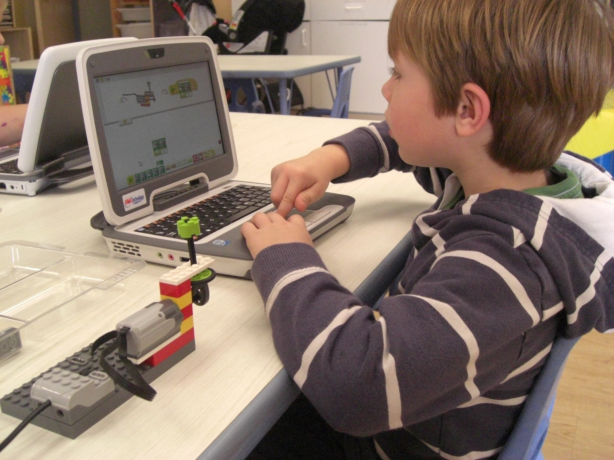 Amy Mandavia Max Crothall, 6, uses a computer to build and program a robot to move and make sound. Kids can do this at Bricks and Motors in Rye Brook, Westchester.
