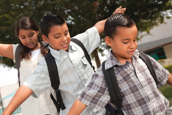 Tips to make the back-to-school season easier on you and your child three children waiting at the bus stop