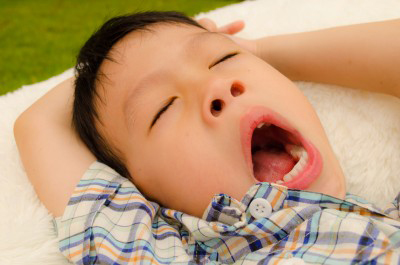 Good sleep hygiene is important to your child's health. sleeping asian boy
