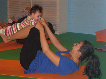 Courtesy <a href='http://nymetroparents.com/listing/Karma-Kids-Yoga'>Karma Kids Yoga</a> mom and baby airplane pilates pose