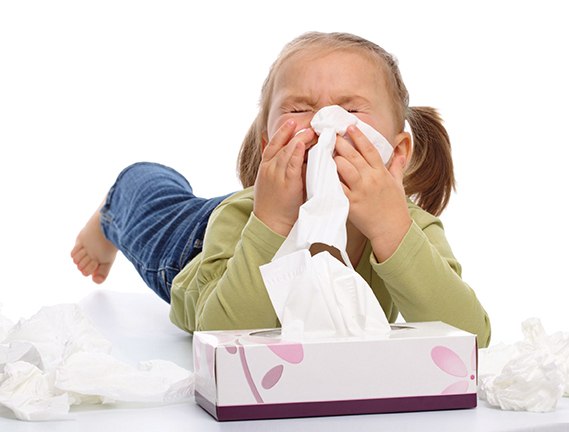 10 Tips to Tame Your Winter Allergies girl with tissues