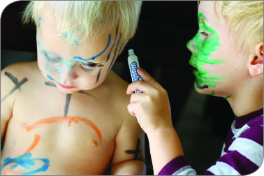 toddler with markers
