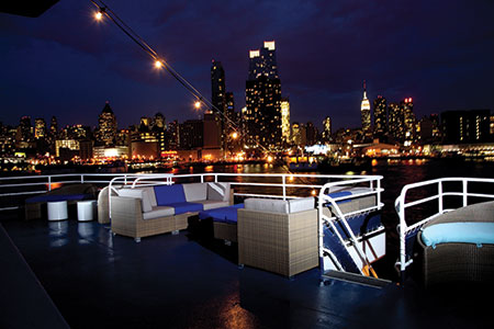 The stunning view of the Manhattan skyline at night from aboard World Yacht
