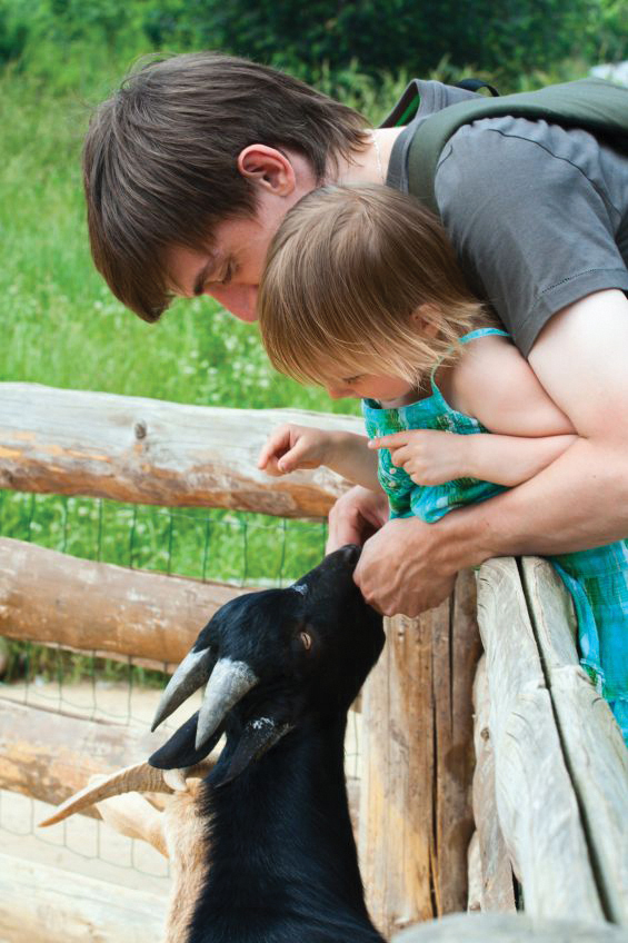 parent and child with goat parent and child with goat