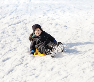 child sledding child sledding