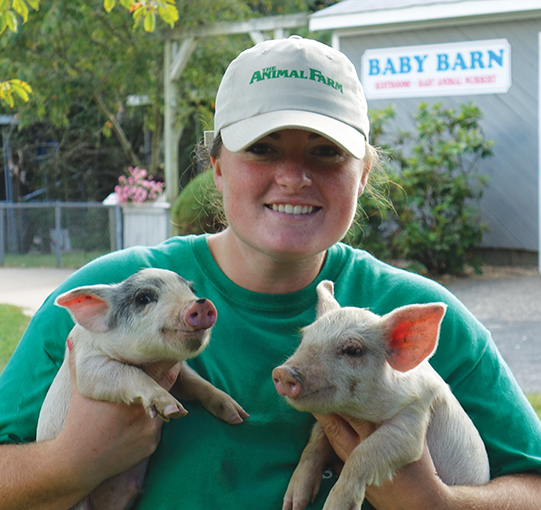 Courtesy The Animal Farm girl holding baby piglets